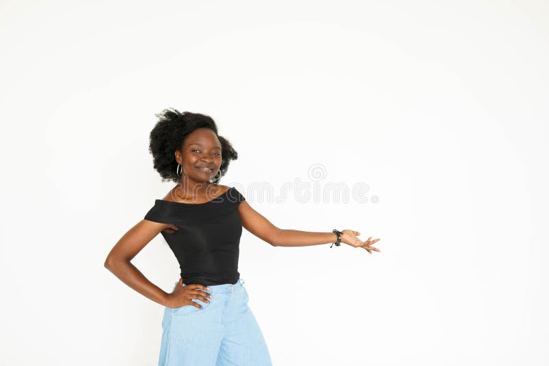 Pointing you advertising. Attractive young African woman pointing away and smiling while standing isolated on white stock images Pointing you advertising. Attractive young African woman pointing away and smiling while standing isolated on white stock images