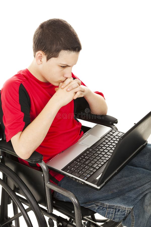 Teen boy in a wheelchair communicating via his laptop computer. Isolated on white. Teen boy in a wheelchair communicating via his laptop computer. Isolated on white.