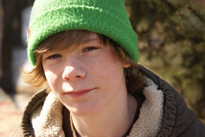 A close-up of a young teen boy outside. A close-up of a young teen boy outside.