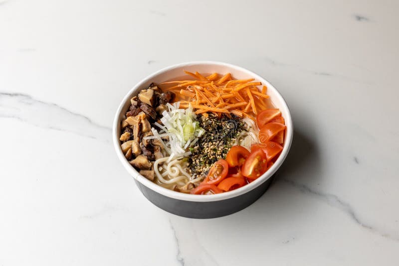 Poke Bowl with Carrot and Mushrooms on Th Emarble Table Stock Photo