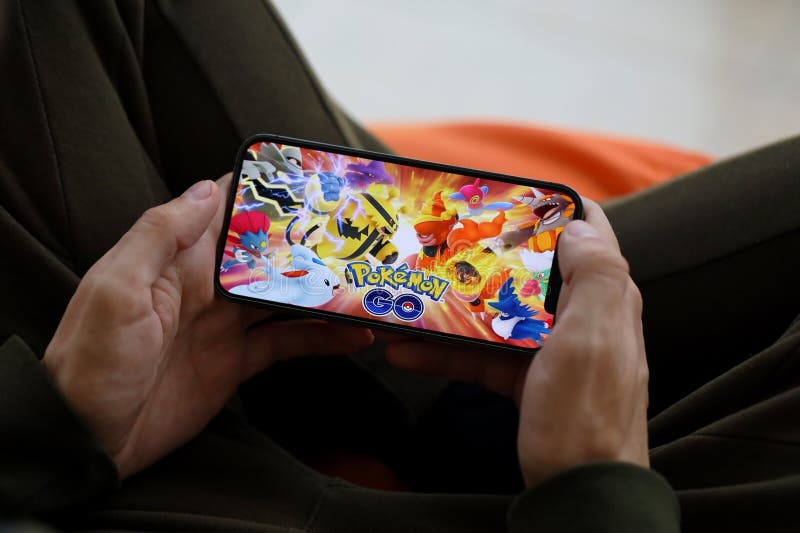 Pokemon GO mobile iOS game on iPhone 15 smartphone screen in male hands during mobile gameplay. Mobile gaming and entertainment on portable device. Pokemon GO mobile iOS game on iPhone 15 smartphone screen in male hands during mobile gameplay. Mobile gaming and entertainment on portable device