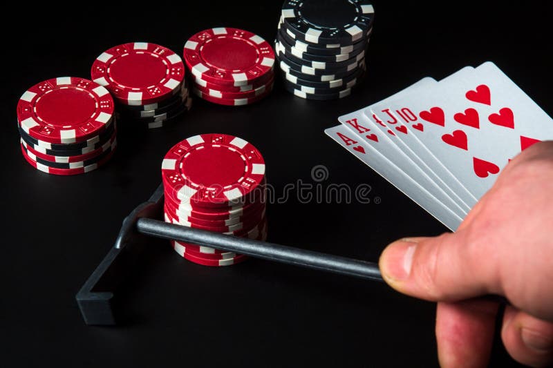 Poker cards with royal flush set combination. Rake in hand takes chips in the casino