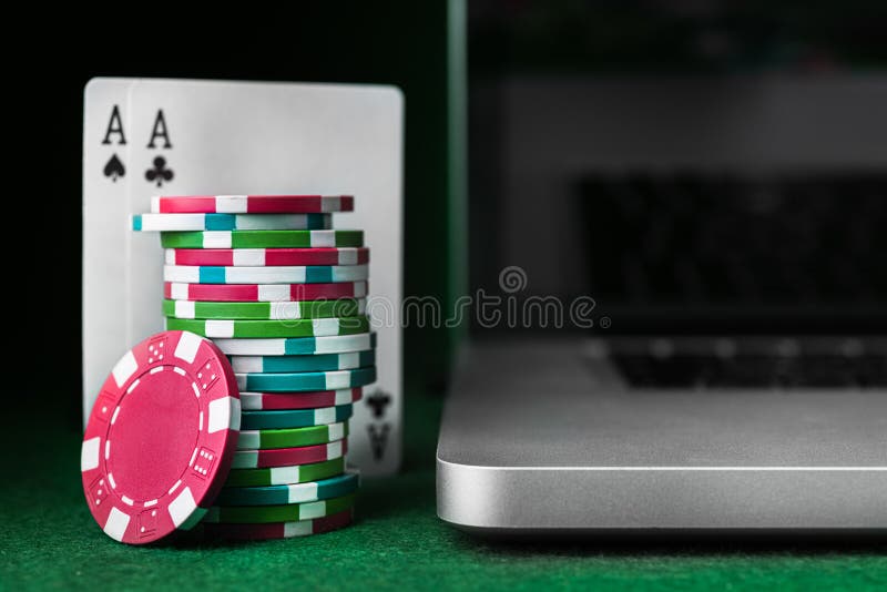 Poker online with laptop and stack of chips
