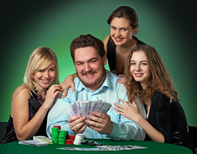 Poker players in casino with cards and chips on green background