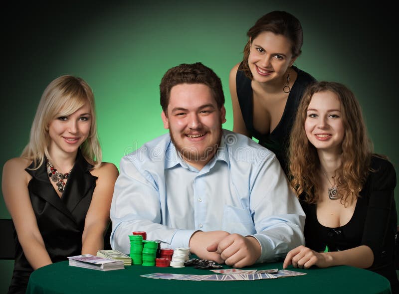 Poker players in casino with cards and chips on green background