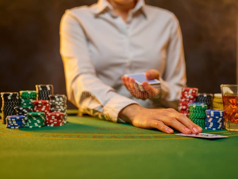 Poker Strategy. Gambling. Casino. Night Club. a Woman Croupier in a White  Uniform Shirt Holds Poker Cards in Her Hands. Many Stock Image - Image of  croupier, amusement: 225362621