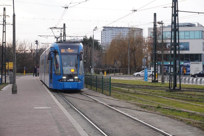 Poland, Krakow 02.18.2020: City blue tram Bombardier NGT8 on the city street. Eco-friendly urban public transport. urban forestry stock image Poland, Krakow 02.18.2020: City blue tram Bombardier NGT8 on the city street. Eco-friendly urban public transport. urban forestry stock image