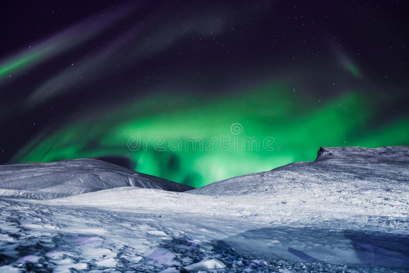 The polar arctic Northern lights aurora borealis sky star in Norway Svalbard in Longyearbyen city moon mountains stock images The polar arctic Northern lights aurora borealis sky star in Norway Svalbard in Longyearbyen city moon mountains stock images