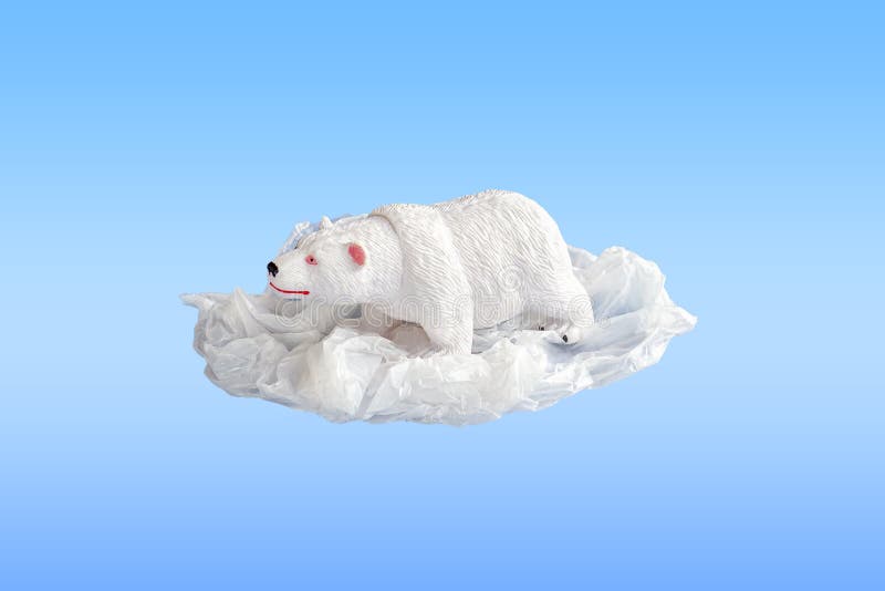 Polar bear toy entangled in a plastic bag on a blue background. Concept of plastic pollution. Environmental Problem. Copy space stock image