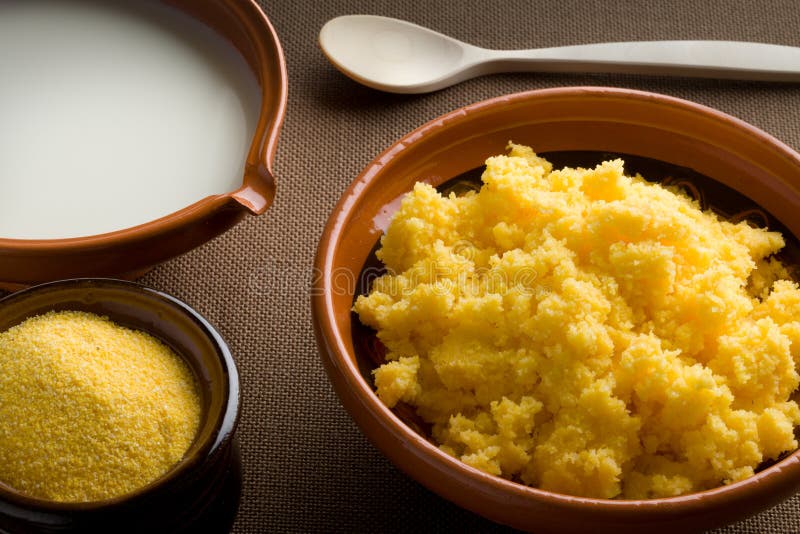 A Slovene Polenta with milk and a wooden spoon. A Slovene Polenta with milk and a wooden spoon