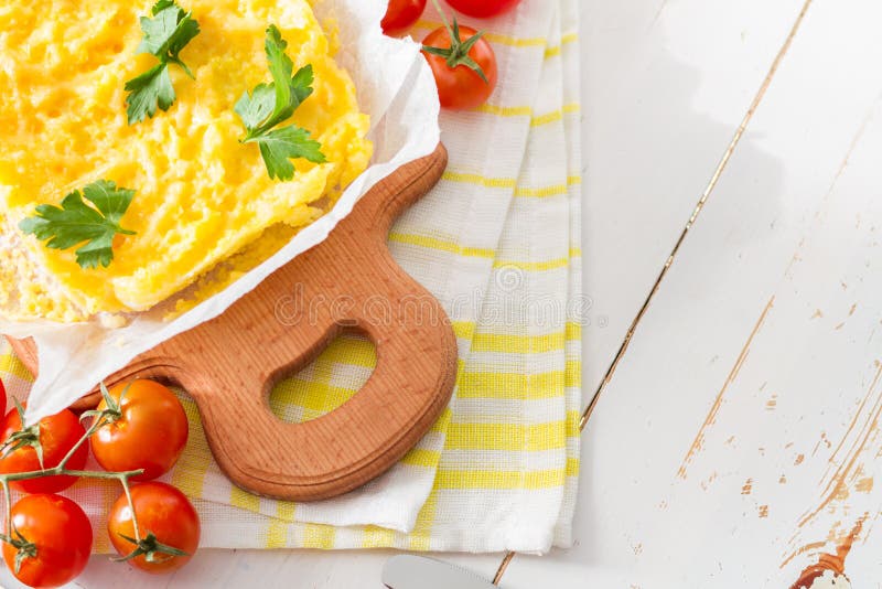 Polenta served on wood board with cherry tomatoes