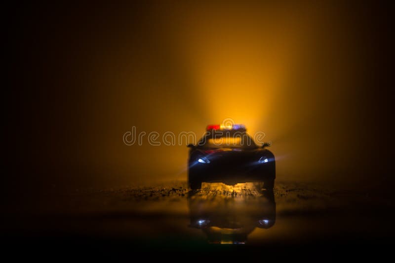 Police cars at night. Police car chasing a car at night with fog background. 911 Emergency response stock image Police cars at night. Police car chasing a car at night with fog background. 911 Emergency response stock image