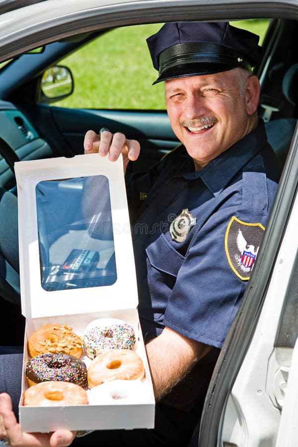 Police Officer - Box of Donuts stock image