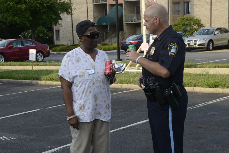 A police officer talks to an African American at a community events