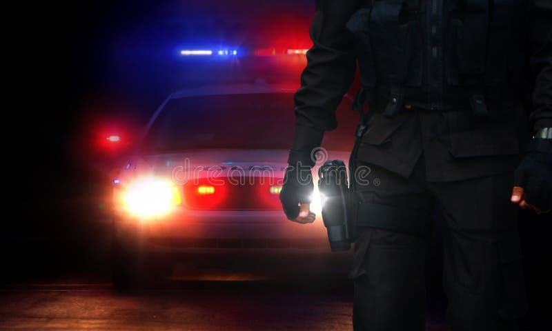 Policeman and patrol car with siren lights on