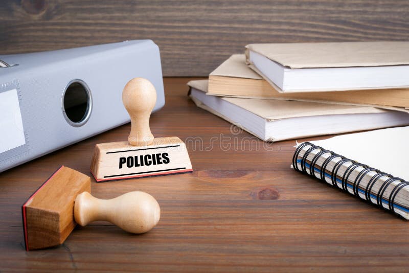 Policies. Rubber Stamp on desk in the Office