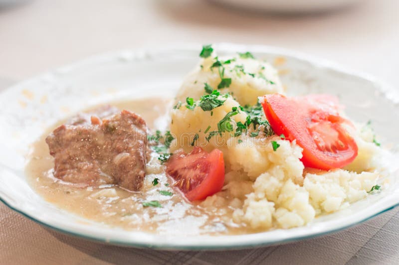Polish Dish Bitki Wolowe with Sauce, Smashed Potatoes with Parsley and Tomato Stock Photo