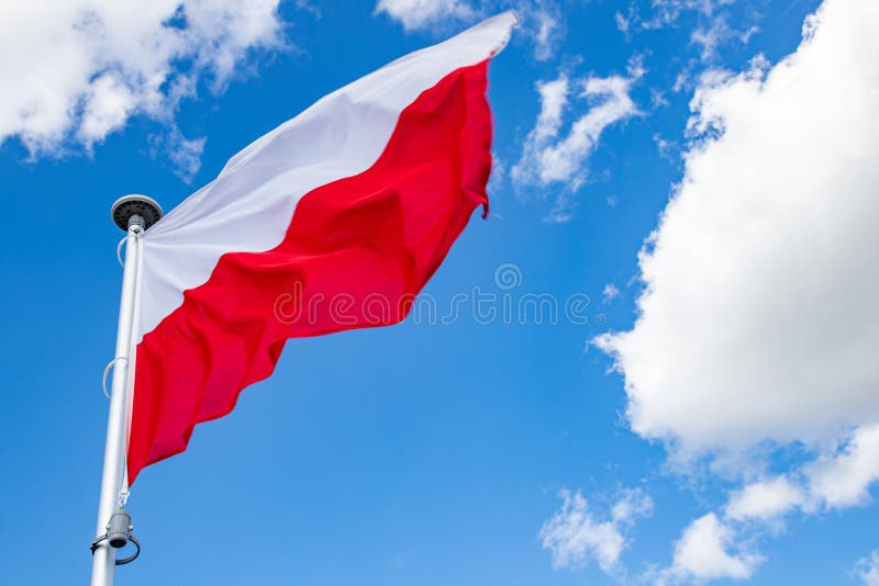 Polish flag on a background of the cloudy sky. National symbol of Poland on the mast royalty free stock photography Polish flag on a background of the cloudy sky. National symbol of Poland on the mast royalty free stock photography