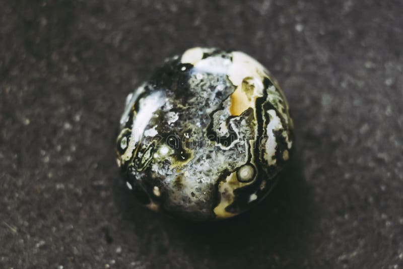 Polished ocean jasper gemstone on a black background