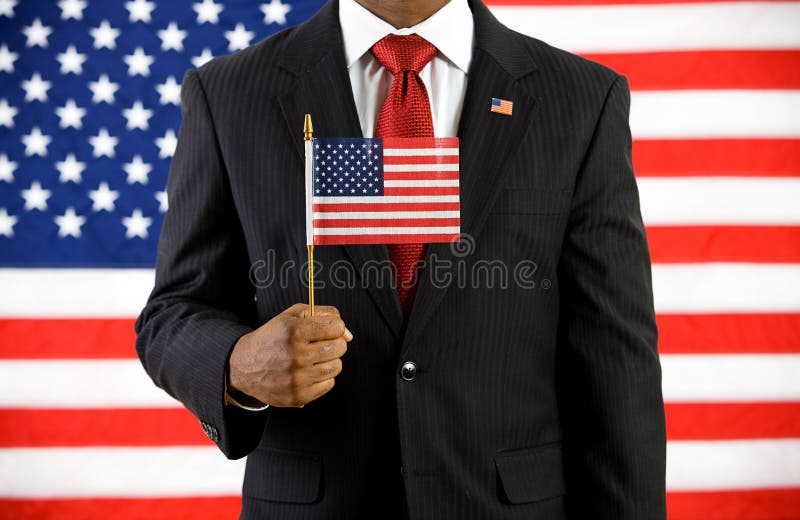 Politician: Holding a United States Flag. Series with an Anonymous African-American politician in front of United States flag. A variety of concepts and props stock images Politician: Holding a United States Flag. Series with an Anonymous African-American politician in front of United States flag. A variety of concepts and props stock images