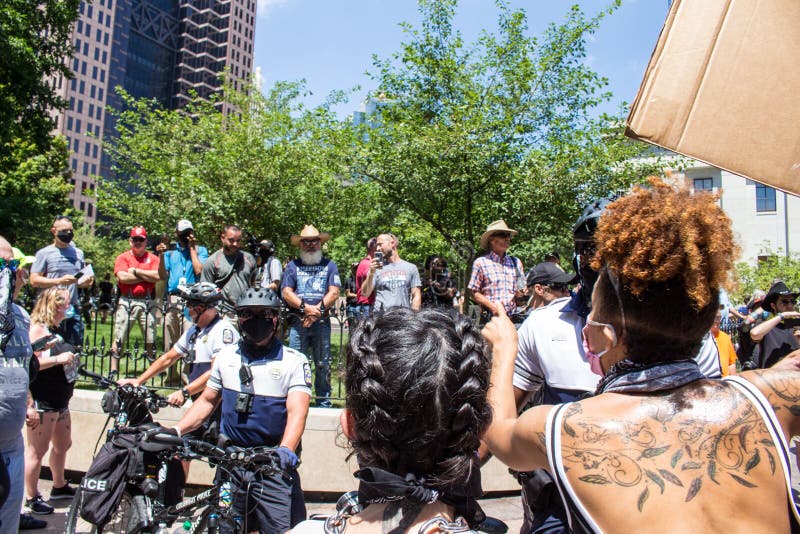 Police officers line up to get between pro-Trump/police demonstrators and a crowd of BLM counter protestors at a conservative rally in support of police, Donald Trump, and against mask mandates. Downtown Columbus Ohio. July 18th 2020. Police officers line up to get between pro-Trump/police demonstrators and a crowd of BLM counter protestors at a conservative rally in support of police, Donald Trump, and against mask mandates. Downtown Columbus Ohio. July 18th 2020.