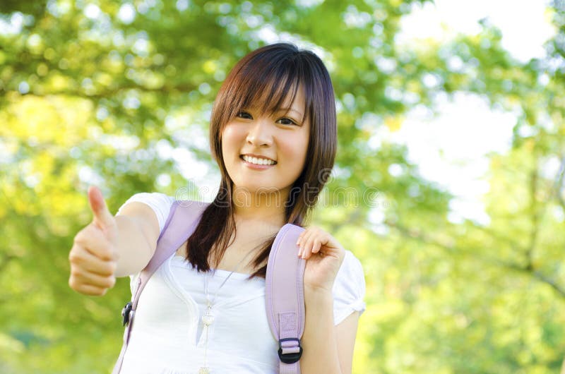 Mixed race thumb up college girl standing at campus. Mixed race thumb up college girl standing at campus