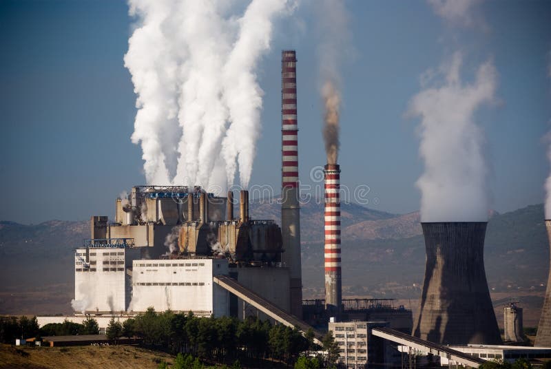 Steaming smoke stack and cooling tower with pollution in Megalopolis, Greece. Steaming smoke stack and cooling tower with pollution in Megalopolis, Greece