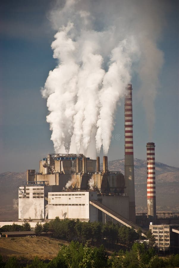 Steaming smoke stack and cooling tower with pollution in Megalopolis, Greece. Steaming smoke stack and cooling tower with pollution in Megalopolis, Greece