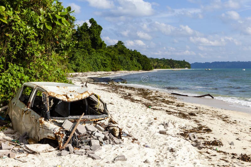 Pollution on the beach of tropical sea. Plastic garbage, car wreck, wood and dirty waste on beach in summer day stock photos Pollution on the beach of tropical sea. Plastic garbage, car wreck, wood and dirty waste on beach in summer day stock photos