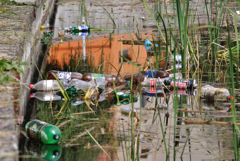 Polluted lake in Dej, Romania. Many plastic bottles and other garbage on lake water. Polluted lake in Dej, Romania. Many plastic bottles and other garbage on lake water.