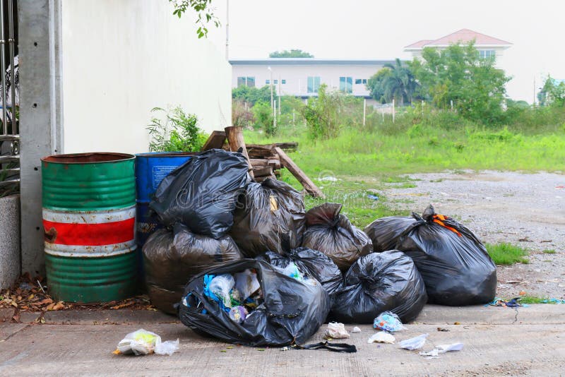 Pollution Bin Garbage, Bin bag black Trash beside the fence home office on street, 3R stock image Pollution Bin Garbage, Bin bag black Trash beside the fence home office on street, 3R stock image
