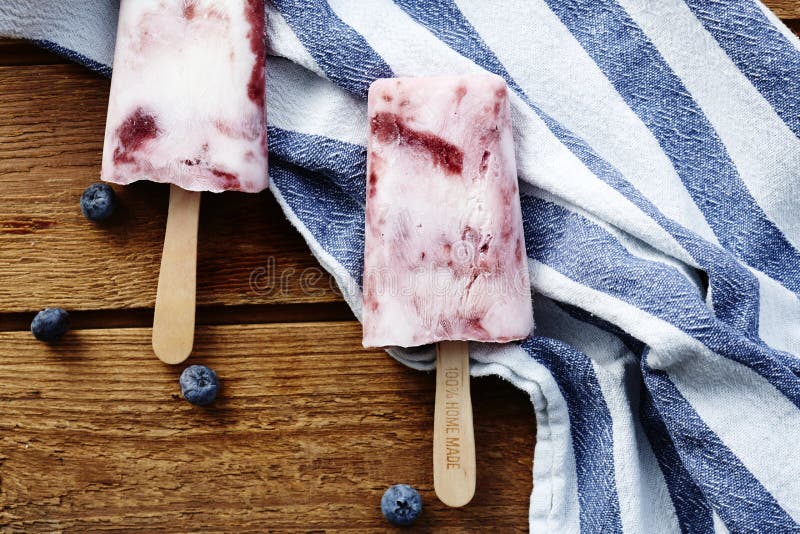 Blueberry smoothie ice lollies in studio. Blueberry smoothie ice lollies in studio