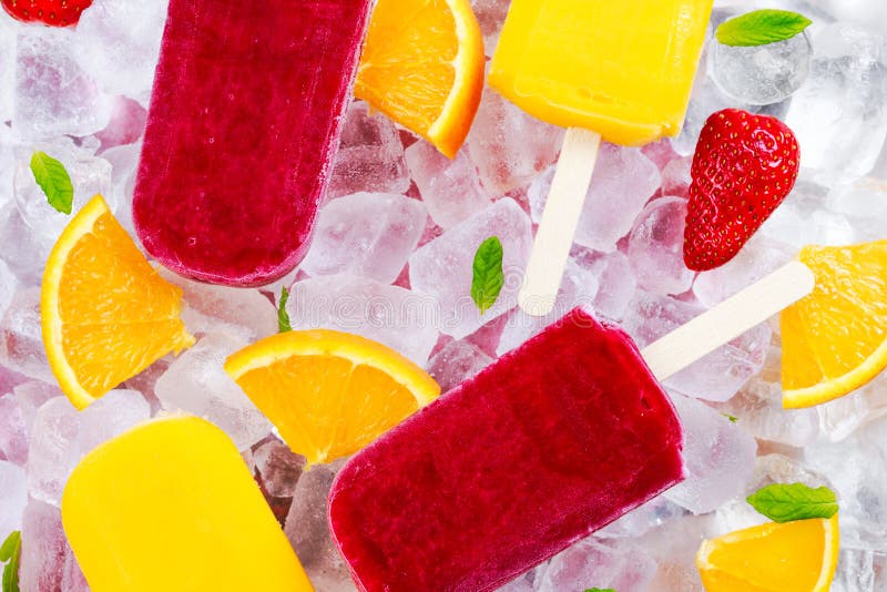 Refreshing fruit popsicle lollies on ice background with berries and peppermint. Refreshing fruit popsicle lollies on ice background with berries and peppermint.