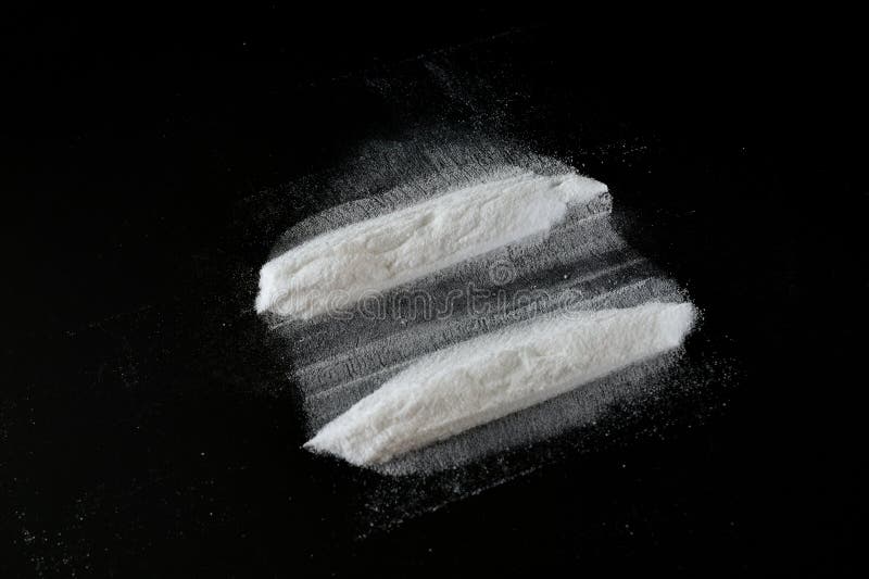 An unknown white powder lies on a black background in two long stripes. An unknown white powder lies on a black background in two long stripes.