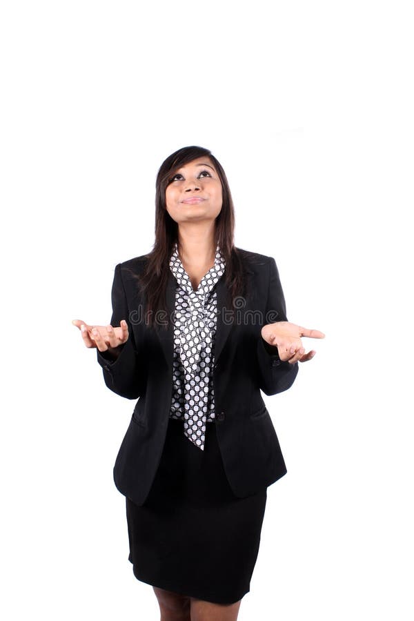 A frustrated Indian businesswoman asking god for help, on white studio background. A frustrated Indian businesswoman asking god for help, on white studio background.