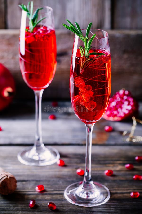 Pomegranate champagne mimosa cocktail with rosemary stock image Pomegranate champagne mimosa cocktail with rosemary stock image