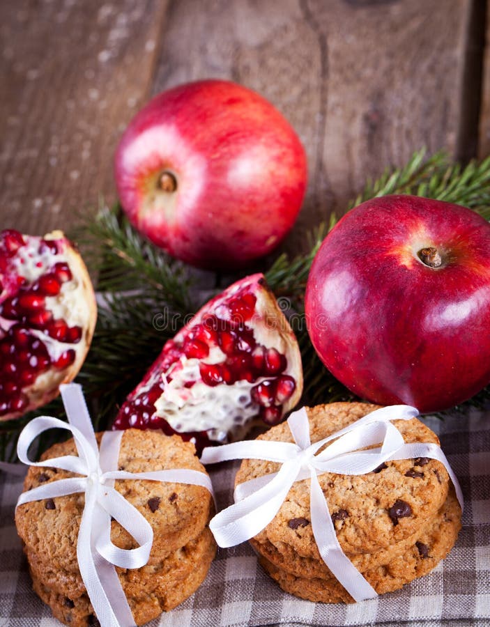 Pomegranate fruit, cookies and apples on wooden background stock images Pomegranate fruit, cookies and apples on wooden background stock images
