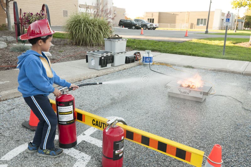 Kid extinguishing a simulated fire demo. Kid extinguishing a simulated fire demo.