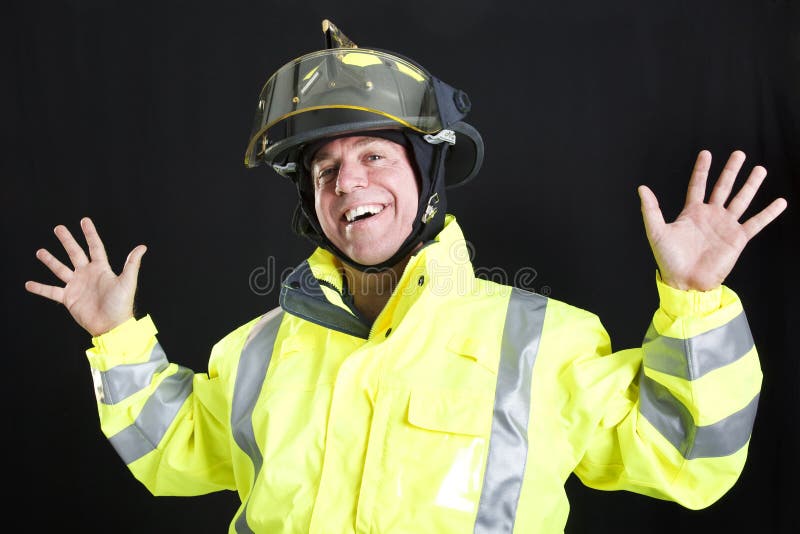 Firefighter lets off steam by goofing around. Photographed on black background. Firefighter lets off steam by goofing around. Photographed on black background.