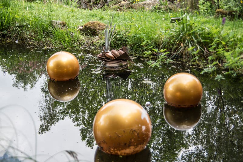 Pond with golden balls stock photo. Image of golden 189073424