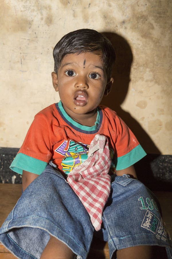 Poor Indian Boy with a Sad and Serious Eyes Looks at the Camera ...