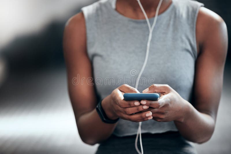 Dry these eyes once again. an unrecognizable woman using her cellphone at the gym. Dry these eyes once again. an unrecognizable woman using her cellphone at the gym