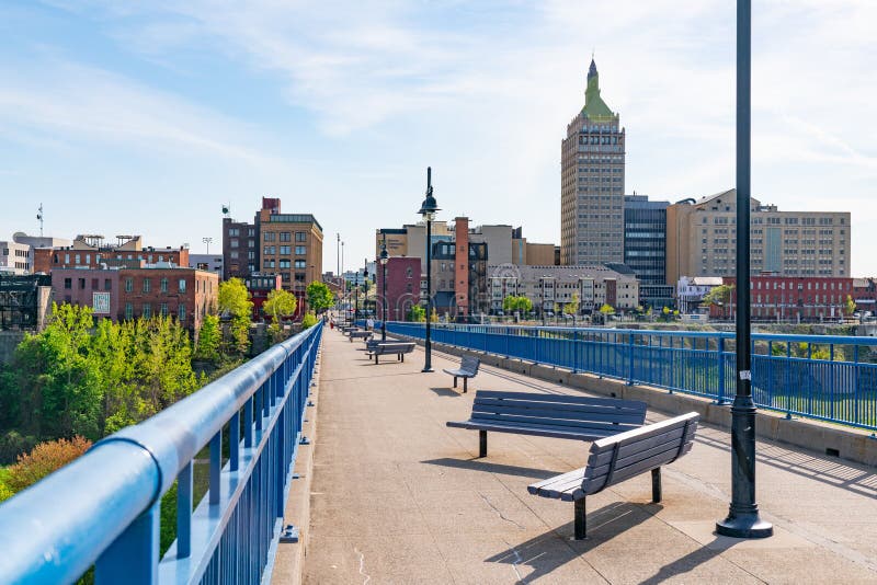 ROCHESTER, NY - MAY 14, 2018: Skyline of Rochester, New York along the Pont De Rennes Pedestrian Bridge which is part of the Genesee Riverway Trail. ROCHESTER, NY - MAY 14, 2018: Skyline of Rochester, New York along the Pont De Rennes Pedestrian Bridge which is part of the Genesee Riverway Trail