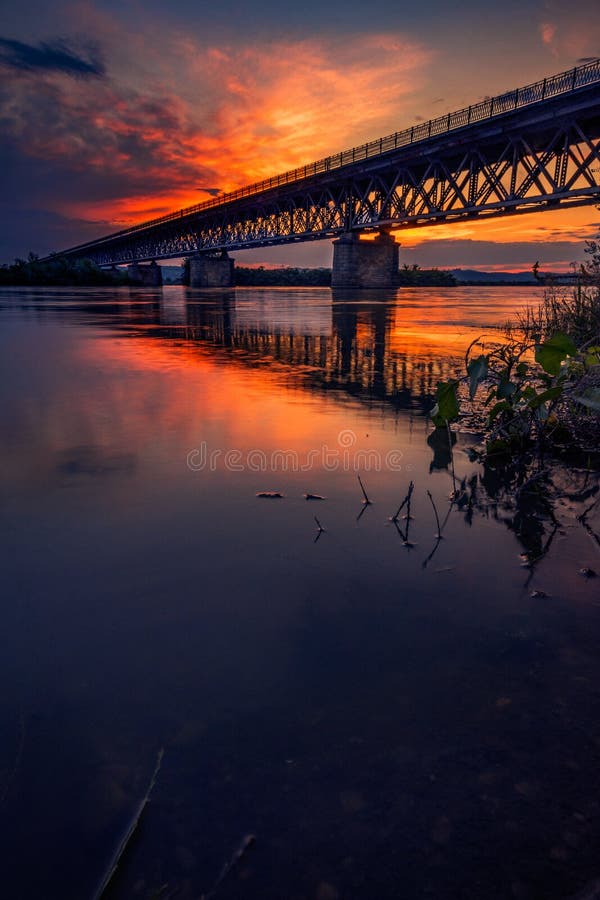 Ponte da estrada que cruza um rio no por do sol com nuvens bonitas sobre imagem de stock royalty free Ponte da estrada que cruza um rio no por do sol com nuvens bonitas sobre imagem de stock royalty free