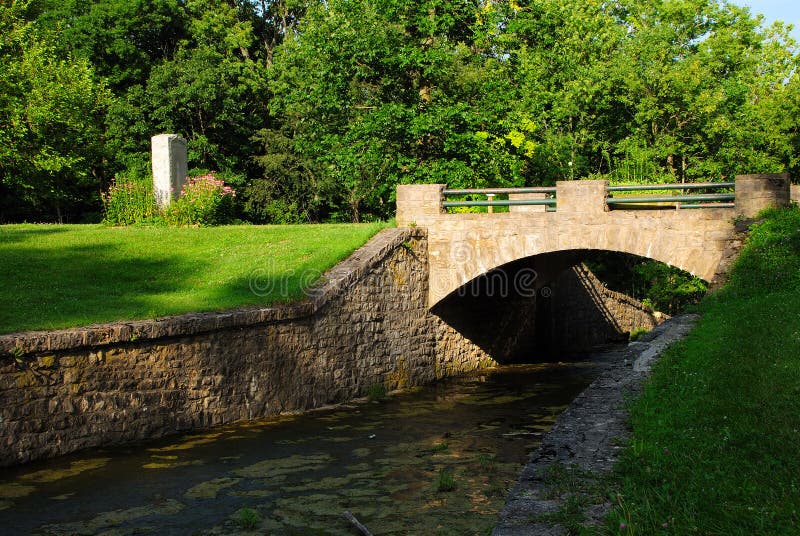 This is a stone bridge. It is located on a spill way for an old mill. This is a stone bridge. It is located on a spill way for an old mill.