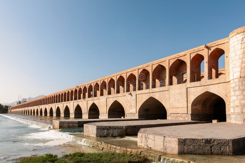 Si-o-Se Pol (Bridge of 33 Arches or Allahverdi Khan Bridge) on Zayanderud River in Isfahan, Iran. Architectural masterpiece and historical heritage. Tourist attraction. Si-o-Se Pol (Bridge of 33 Arches or Allahverdi Khan Bridge) on Zayanderud River in Isfahan, Iran. Architectural masterpiece and historical heritage. Tourist attraction.