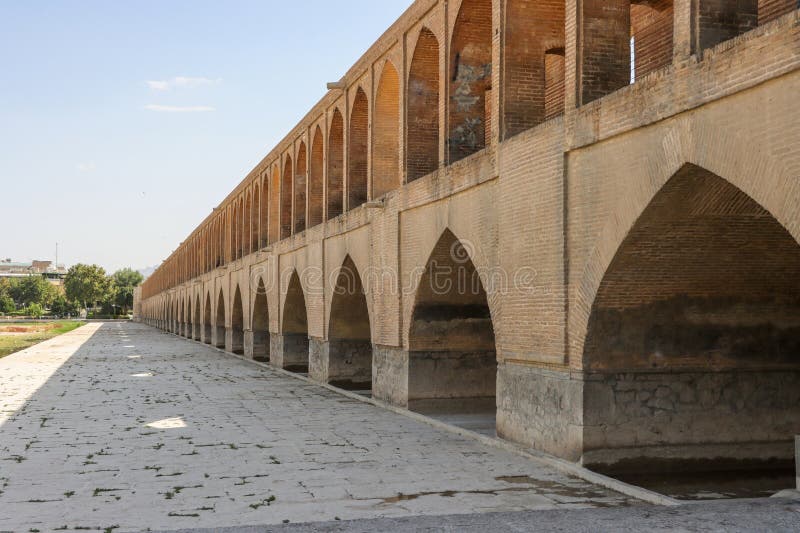 Isfahan, Iran - July 31 2023: Si-o-se-pol Bridge. The famous two-storey stone bridge with 33 arches over the Zayandeh River in Isfahan. Isfahan, Iran - July 31 2023: Si-o-se-pol Bridge. The famous two-storey stone bridge with 33 arches over the Zayandeh River in Isfahan.