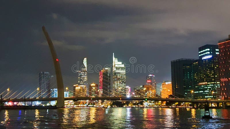 Ho Chi Minh City, Vietnam - November 3, 2023 : View Of Ba Son Suspension Bridge And Skyscrapers In Central Of Ho Chi Minh City At Night. Ho Chi Minh City, Vietnam - November 3, 2023 : View Of Ba Son Suspension Bridge And Skyscrapers In Central Of Ho Chi Minh City At Night.