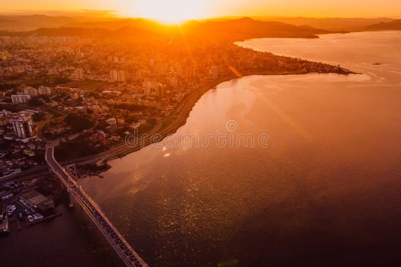 Cable bridge and downtown with sunset light in Florianopolis, Brazil. Drone view. Cable bridge and downtown with sunset light in Florianopolis, Brazil. Drone view