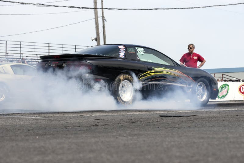 Pontiac drag car making a smoke show stock images